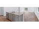 Modern kitchen island with stainless steel dishwasher, sink, and gray granite countertops at 5568 Bowmore Blvd, Ravenel, SC 29470