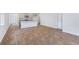 Open-concept living space with modern floors leading to a kitchen with stainless appliances at 5568 Bowmore Blvd, Ravenel, SC 29470