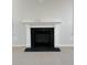 Elegant fireplace with a classic white mantel and black tile surround at 8801 Lannister Dr, North Charleston, SC 29420