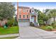 Two-story orange house with a white garage door and landscaped front yard at 1428 Bloomingdale Ln, Mount Pleasant, SC 29466