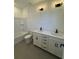 Main bathroom with double vanity, white cabinets, quartz countertops, and a bathtub at 100 Gray Pine Ln, Summerville, SC 29483