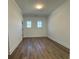 Bright bedroom with hardwood floors and two windows at 100 Gray Pine Ln, Summerville, SC 29483