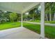 Inviting front porch with sturdy white support columns overlooks the well-manicured front yard and charming neighborhood at 100 Gray Pine Ln, Summerville, SC 29483