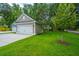 A detached two-car garage sits adjacent to a well-maintained lawn and charming landscaping at 100 Gray Pine Ln, Summerville, SC 29483