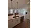 Modern kitchen island with white cabinets, quartz countertops, and a stainless steel sink at 100 Gray Pine Ln, Summerville, SC 29483