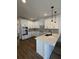 L-shaped kitchen with white cabinets, gray tile backsplash, and quartz countertops at 100 Gray Pine Ln, Summerville, SC 29483