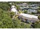 Aerial shot of a condo community featuring mature trees, green spaces, and multiple tennis courts at 1616 Live Oak Park, Seabrook Island, SC 29455