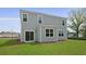 Back exterior view of home with gray siding, bright green grass and sliding glass door at 183 Morning View Way, Moncks Corner, SC 29461
