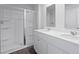 Bright bathroom with double sinks, white cabinetry, and a stand-up shower with glass doors at 183 Morning View Way, Moncks Corner, SC 29461