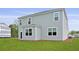Side view of the property with green grass and gray siding, and white trim at 183 Morning View Way, Moncks Corner, SC 29461
