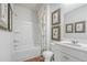 Modern bathroom with tub/shower, white vanity, and wood-look floors at 236 Watersglen Dr, Summerville, SC 29486