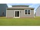 The backyard shows a house with a sliding glass door and view of a green lawn at 355 Willows Crescent Dr, Moncks Corner, SC 29461