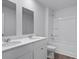 Well-lit bathroom with double sinks, a toilet, and white cabinet at 357 Willows Crescent Dr, Moncks Corner, SC 29461