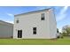 Rear exterior of home featuring vinyl siding, sliding glass door, and a well-maintained lawn at 357 Willows Crescent Dr, Moncks Corner, SC 29461