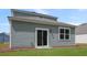 Back of house showing the siding, sliding glass door, and adjacent lawn at 369 Willows Crescent Dr, Moncks Corner, SC 29461