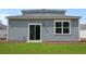 Rear of the home with siding, manicured lawn, sliding glass door and a bright window at 369 Willows Crescent Dr, Moncks Corner, SC 29461