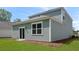 Exterior view showcasing the home's siding, window, sliding glass door and well-maintained lawn at 369 Willows Crescent Dr, Moncks Corner, SC 29461