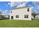 Back of home with a sliding glass door and lawn at 405 Peachwood Ln, Moncks Corner, SC 29461
