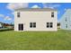 Back of home with sliding glass door and lawn at 405 Peachwood Ln, Moncks Corner, SC 29461