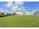 Spacious backyard with lush green grass surrounding the home at 405 Peachwood Ln, Moncks Corner, SC 29461