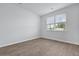 Well-lit bedroom showcasing stylish flooring and a window at 405 Peachwood Ln, Moncks Corner, SC 29461