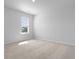 Bright bedroom featuring neutral carpet and a window bringing in natural light at 405 Peachwood Ln, Moncks Corner, SC 29461