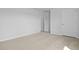 Neutral bedroom featuring a door, closet, and neutral carpet at 405 Peachwood Ln, Moncks Corner, SC 29461