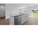 Well-lit kitchen features granite counters, stainless steel appliances, and access to the backyard at 405 Peachwood Ln, Moncks Corner, SC 29461