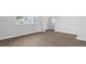 Bright living room features lovely wood-look flooring and abundant natural light from the large window at 405 Peachwood Ln, Moncks Corner, SC 29461