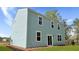 The backyard features a well-manicured lawn and exterior of the home with sliding glass doors at 361 Willows Crescent Dr, Moncks Corner, SC 29461