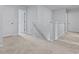 The upstairs hallway is carpeted and has a view down the stairway at 361 Willows Crescent Dr, Moncks Corner, SC 29461