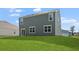 An expansive backyard with lush green grass and a home with blue siding and white trim at 373 Willows Crescent Dr, Moncks Corner, SC 29461