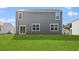 Expansive backyard with lush green grass and a home with gray siding and white trim at 373 Willows Crescent Dr, Moncks Corner, SC 29461