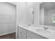 This bathroom features double sinks, bright lighting and wood flooring at 373 Willows Crescent Dr, Moncks Corner, SC 29461