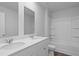 This bathroom features double sinks, bright lighting and a shower-tub combo at 373 Willows Crescent Dr, Moncks Corner, SC 29461