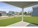 View of the backyard with street views from under a covered patio at 374 Willows Crescent Dr, Moncks Corner, SC 29461