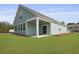 Well-maintained backyard with a covered patio, lush green lawn, and stylish exterior at 374 Willows Crescent Dr, Moncks Corner, SC 29461