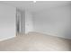 A bedroom featuring neutral carpet, a door, and white trim at 374 Willows Crescent Dr, Moncks Corner, SC 29461