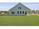 Charming home exterior with blue siding, bright windows, and a spacious lawn at 374 Willows Crescent Dr, Moncks Corner, SC 29461