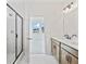 Bright bathroom with a double sink vanity, large mirror, and glass-enclosed shower stall at 1094 Glenshaw St, North Charleston, SC 29405