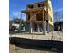 New home construction featuring an elevated foundation and contemporary design awaiting finishing touches at 1094 Glenshaw St, North Charleston, SC 29405