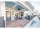 Inviting covered front porch with brick flooring, a ceiling fan, and comfortable seating area with chairs at 420 Carolina Cherry Ct # 102, Charleston, SC 29414