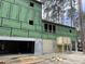 Exterior view of new home construction showcasing the garage and ZIP System at 1709 Vireo Ct, Johns Island, SC 29455