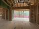 View of an unfinished covered porch with pink railings off a room with exposed framework in a home under construction at 1709 Vireo Ct, Johns Island, SC 29455