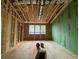 Unfinished construction shows exposed framing, bare subfloor, and a view to the outside through window openings at 1709 Vireo Ct, Johns Island, SC 29455