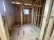 Inside a framed room; shows exposed beams, bare subfloor, and a window providing natural light in unfinished construction at 1709 Vireo Ct, Johns Island, SC 29455