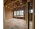 Spacious unfinished room featuring exposed framing, bare subfloor, and several window openings offering natural light at 1709 Vireo Ct, Johns Island, SC 29455