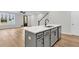 Gray kitchen island with white quartz countertop and stainless steel appliances at 166 Cantona Dr, Summerville, SC 29483