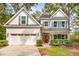 Charming two-story home featuring a bright red front door, blue shutters, and a well-manicured lawn at 1532 Joe Rouse Rd, Mount Pleasant, SC 29466