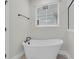 Elegant bathroom featuring a freestanding tub with modern fixtures and large windows at 4 Wappoo Trace Ln, Summerville, SC 29486